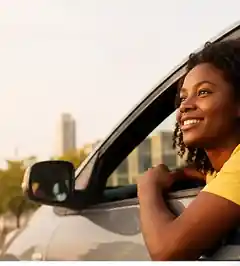 A rider in a car in an urban Zimbabwe setting